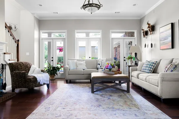 a living room with furniture and wooden floor