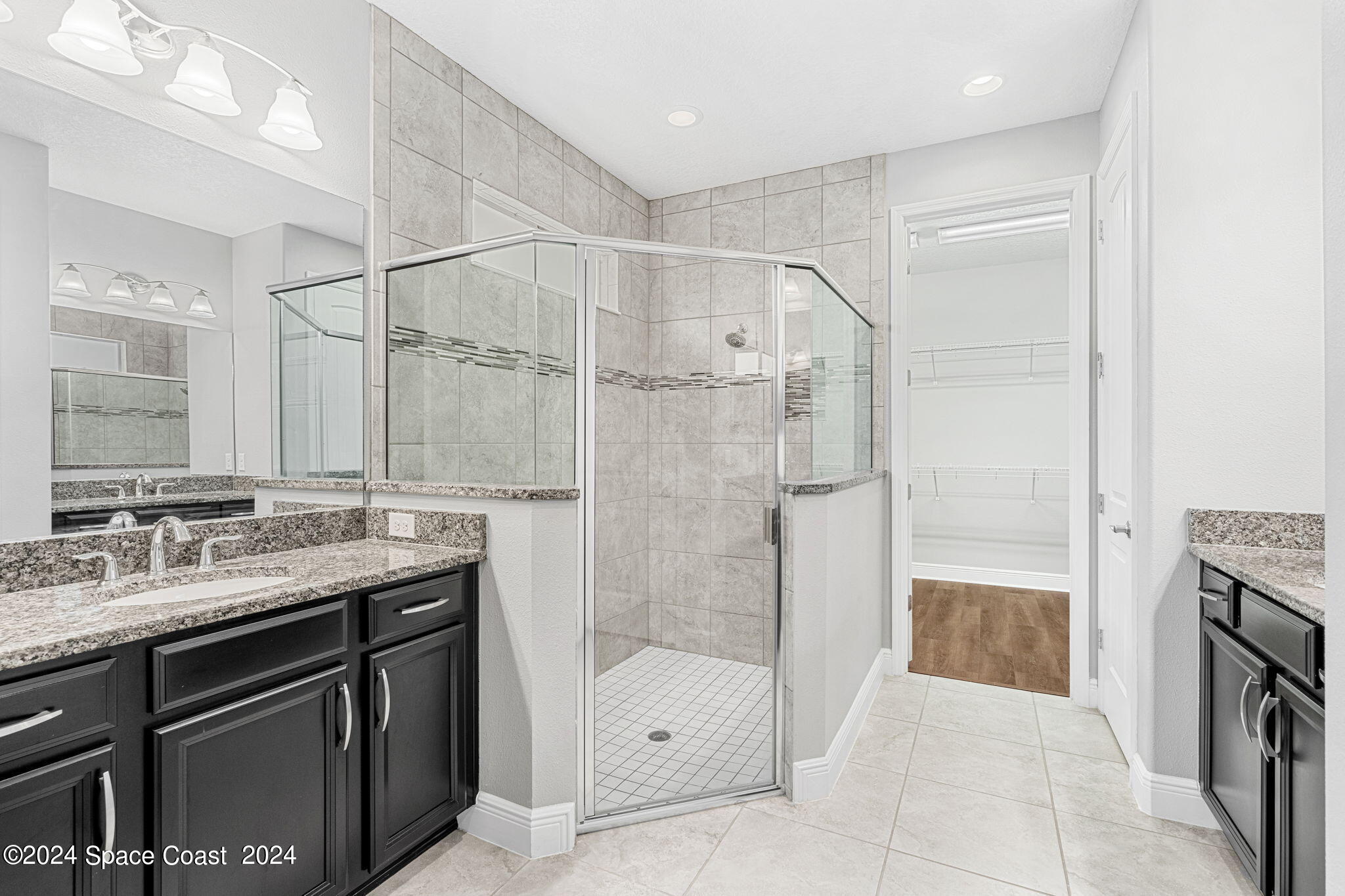 3034 Casterton Drive Melbourne, FL 32940 - Photo 14 of 38 a bathroom with a shower sink and mirror