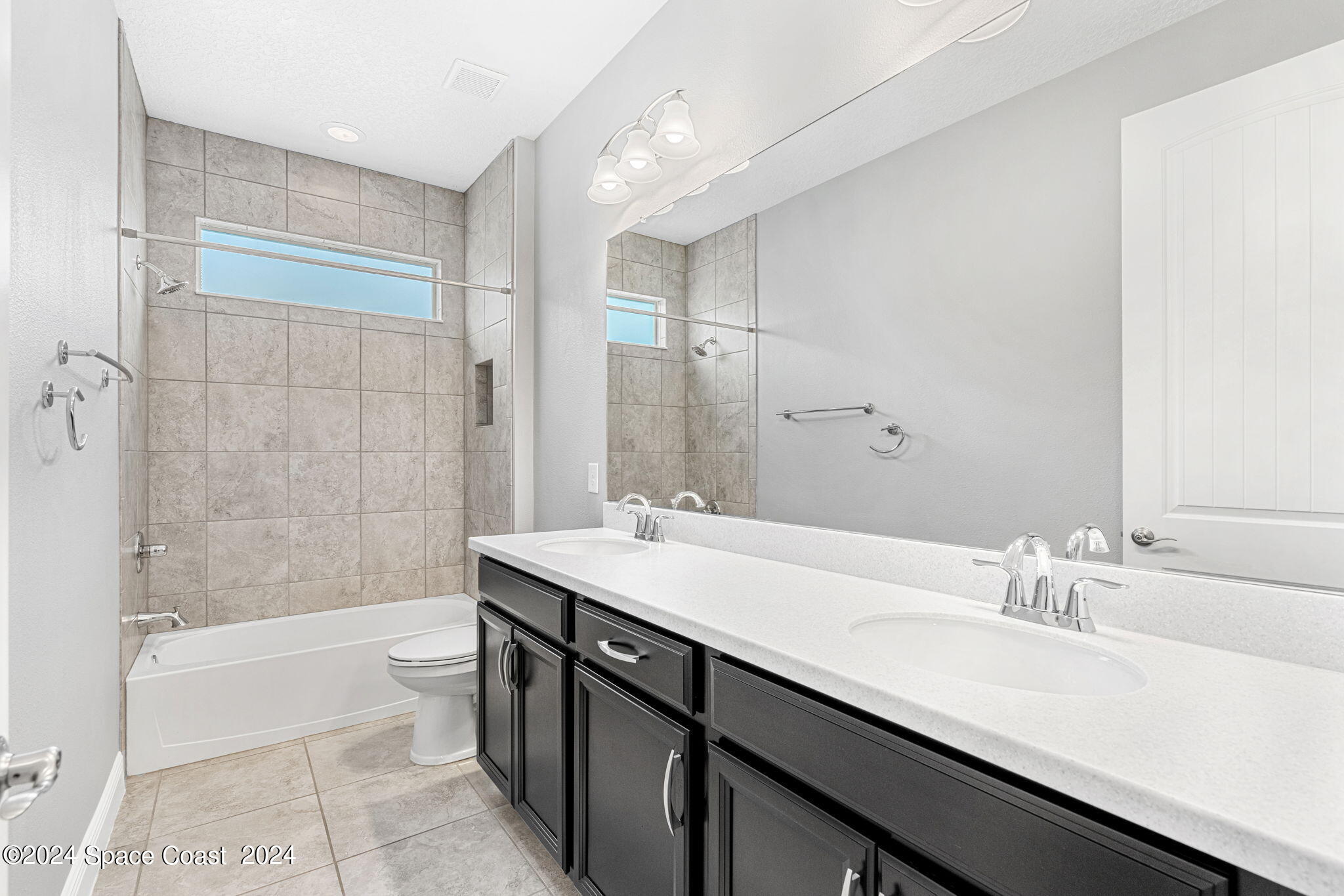 3034 Casterton Drive Melbourne, FL 32940 - Photo 19 of 38 a bathroom with a sink double vanity granite tub shower and a mirror