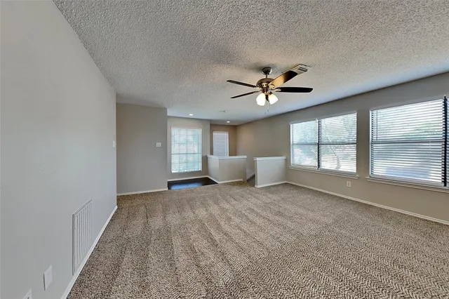 a view of a livingroom with a ceiling fan and window