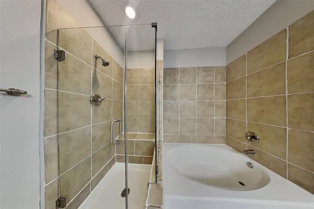a bathroom with a bathtub and a shower