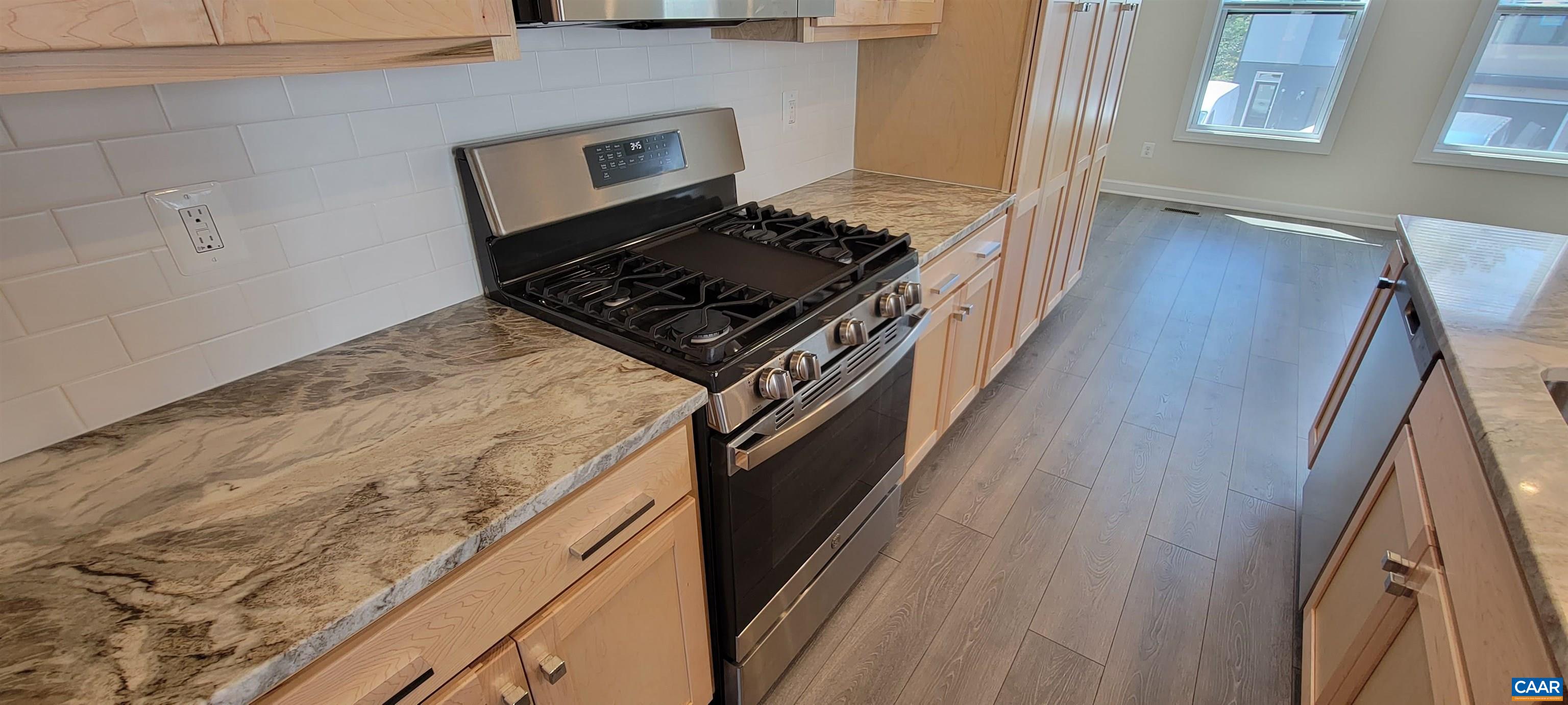 2245 Fowler Street Charlottesville, VA 22901 - Photo 13 of 38 a kitchen with granite countertop a stove and a refrigerator