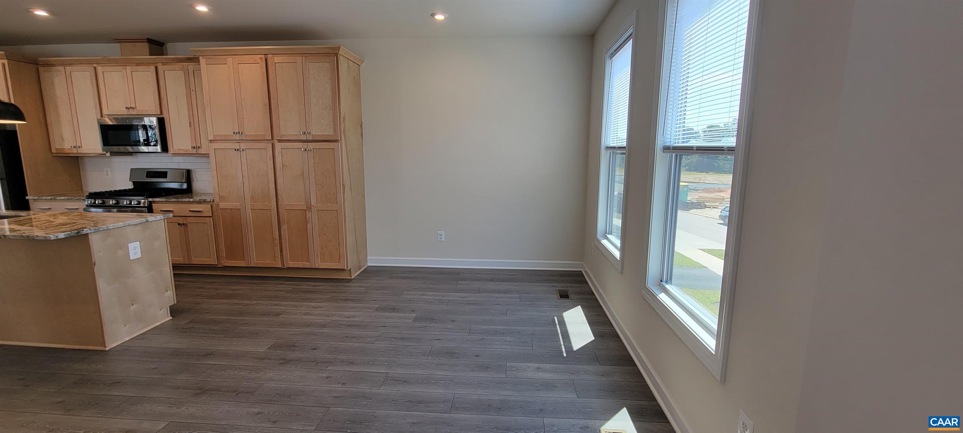 2245 Fowler Street Charlottesville, VA 22901 - Photo 14 of 38 a view of a kitchen with a sink refrigerator and wooden floor