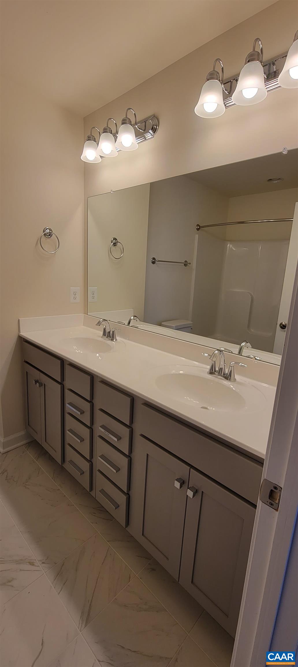 2245 Fowler Street Charlottesville, VA 22901 - Photo 32 of 38 a bathroom with a double vanity sink and a mirror