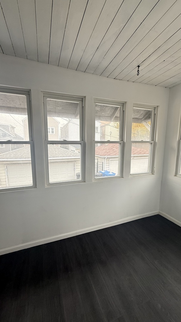 2942 West Pershing Road Chicago, IL 60632 - Photo 8 of 16 a view of an empty room with wooden floor and a window