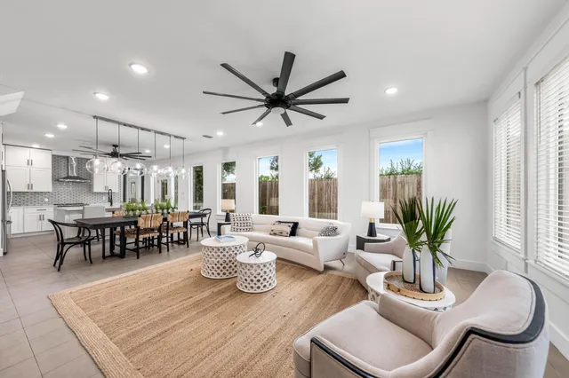 a living room with furniture potted plant and window