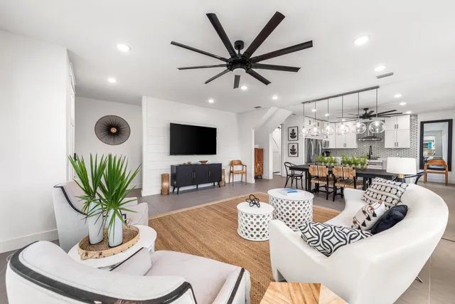 a living room with furniture a window and a flat screen tv