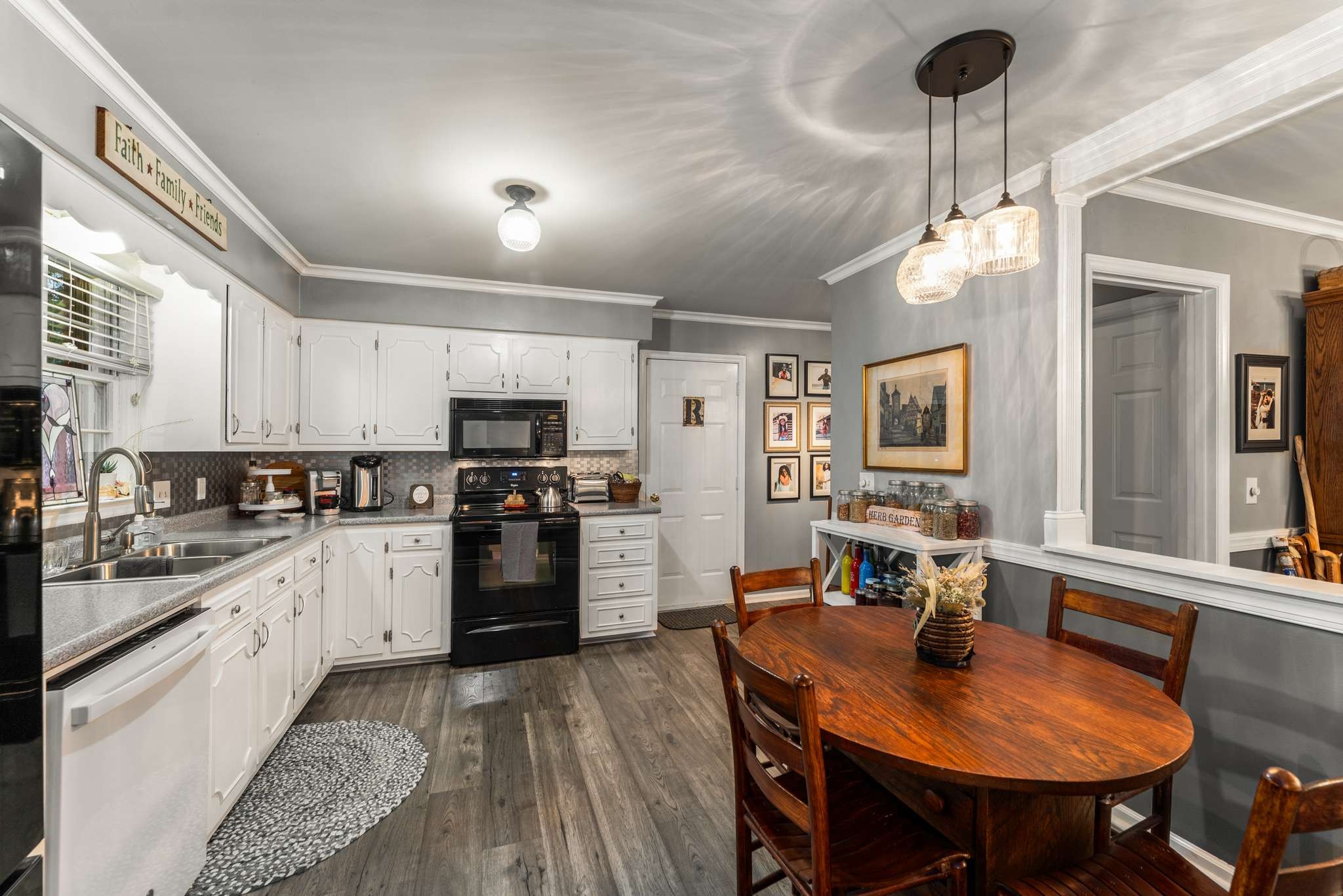 513 Rose Circle Murfreesboro, TN 37128 - Photo 13 of 37 a kitchen with stainless steel appliances granite countertop a stove refrigerator a sink dishwasher a dining table and chairs with wooden floor