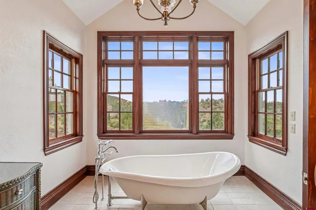 a bathroom with a bathtub and a window