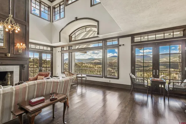 a living room with furniture and floor to ceiling windows