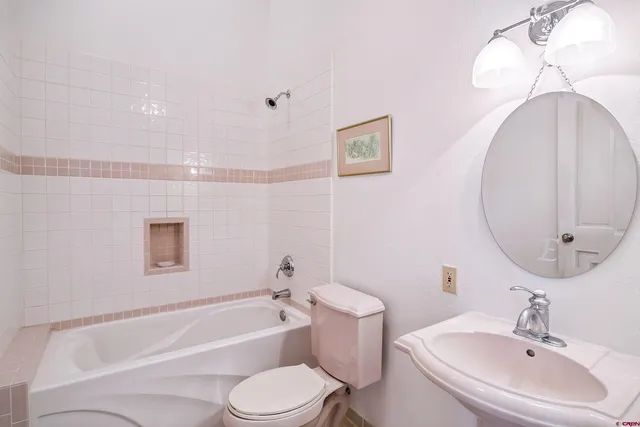 a bathroom with a sink a toilet and bathtub