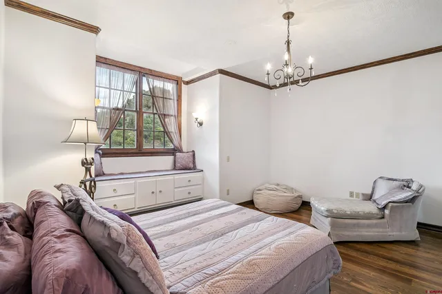 a bedroom with a bed couch and window