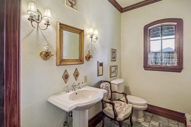 a bathroom with a toilet sink and mirror