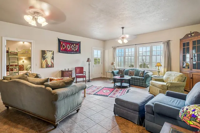 a living room with furniture a chandelier and a window