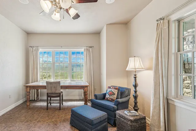 a living room with furniture a lamp and a window