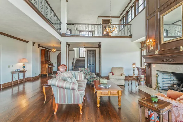 a view of a livingroom with furniture a fireplace wooden floor and a fireplace