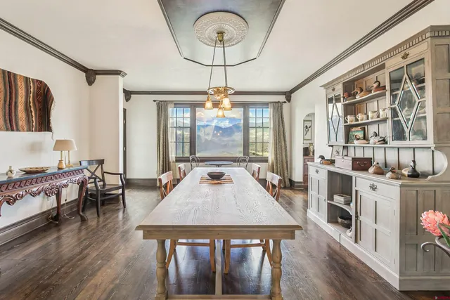 a living room with furniture a dining table and a chandelier