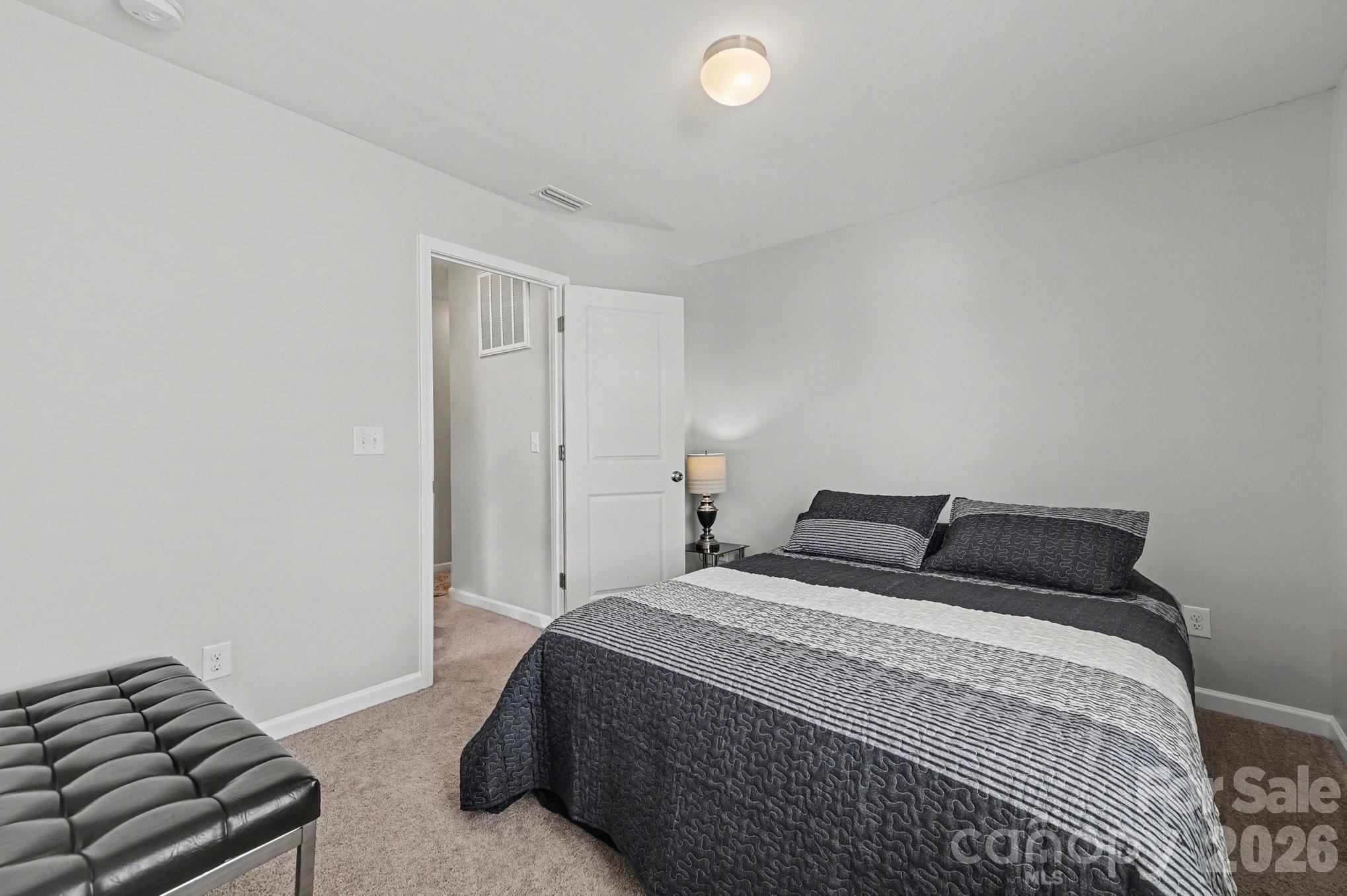 12527 Gotland Road Midland, NC 28107 - Photo 13 of 24 a bedroom with a bed and a couch