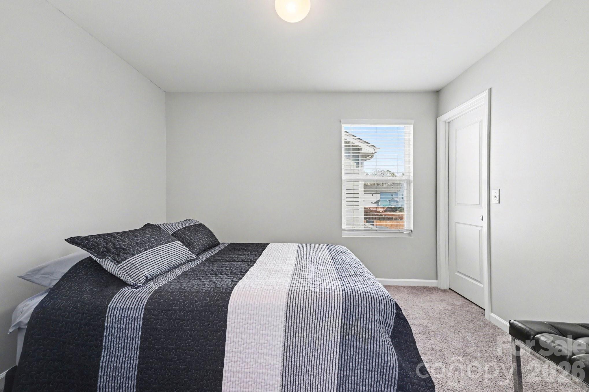 12527 Gotland Road Midland, NC 28107 - Photo 14 of 24 a bedroom with a bed and a window