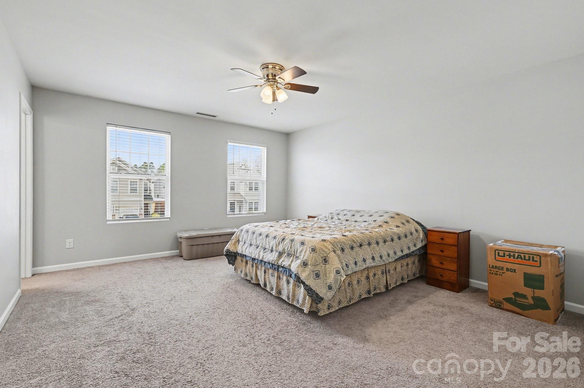 12527 Gotland Road Midland, NC 28107 - Photo 17 of 24 a bedroom with a bed and a chandelier