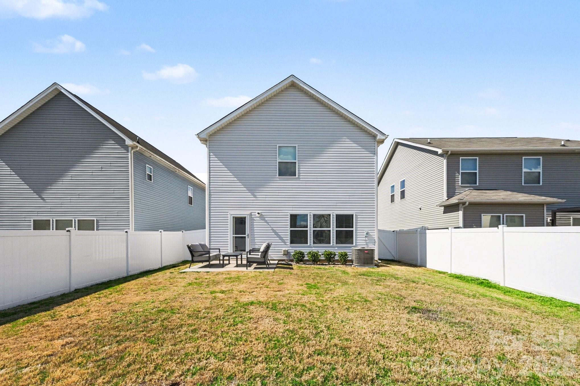 12527 Gotland Road Midland, NC 28107 - Photo 22 of 24 a view of a backyard with a table and chairs under an umbrella