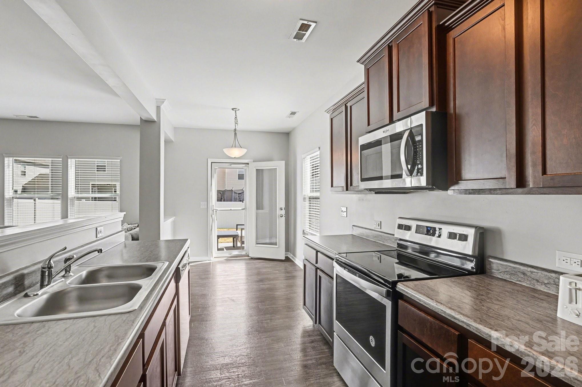 12527 Gotland Road Midland, NC 28107 - Photo 8 of 24 a kitchen that has a sink and a stove