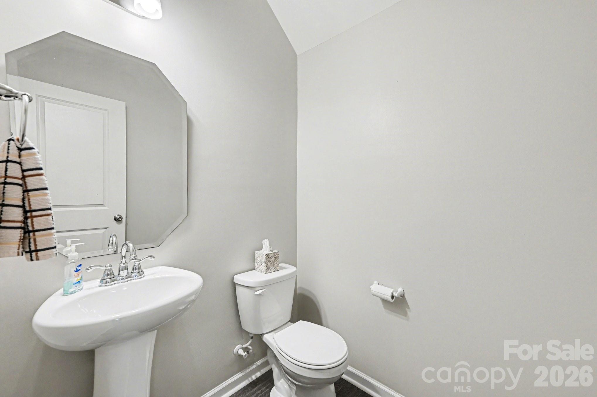 12527 Gotland Road Midland, NC 28107 - Photo 9 of 24 a bathroom with a sink a toilet and mirror