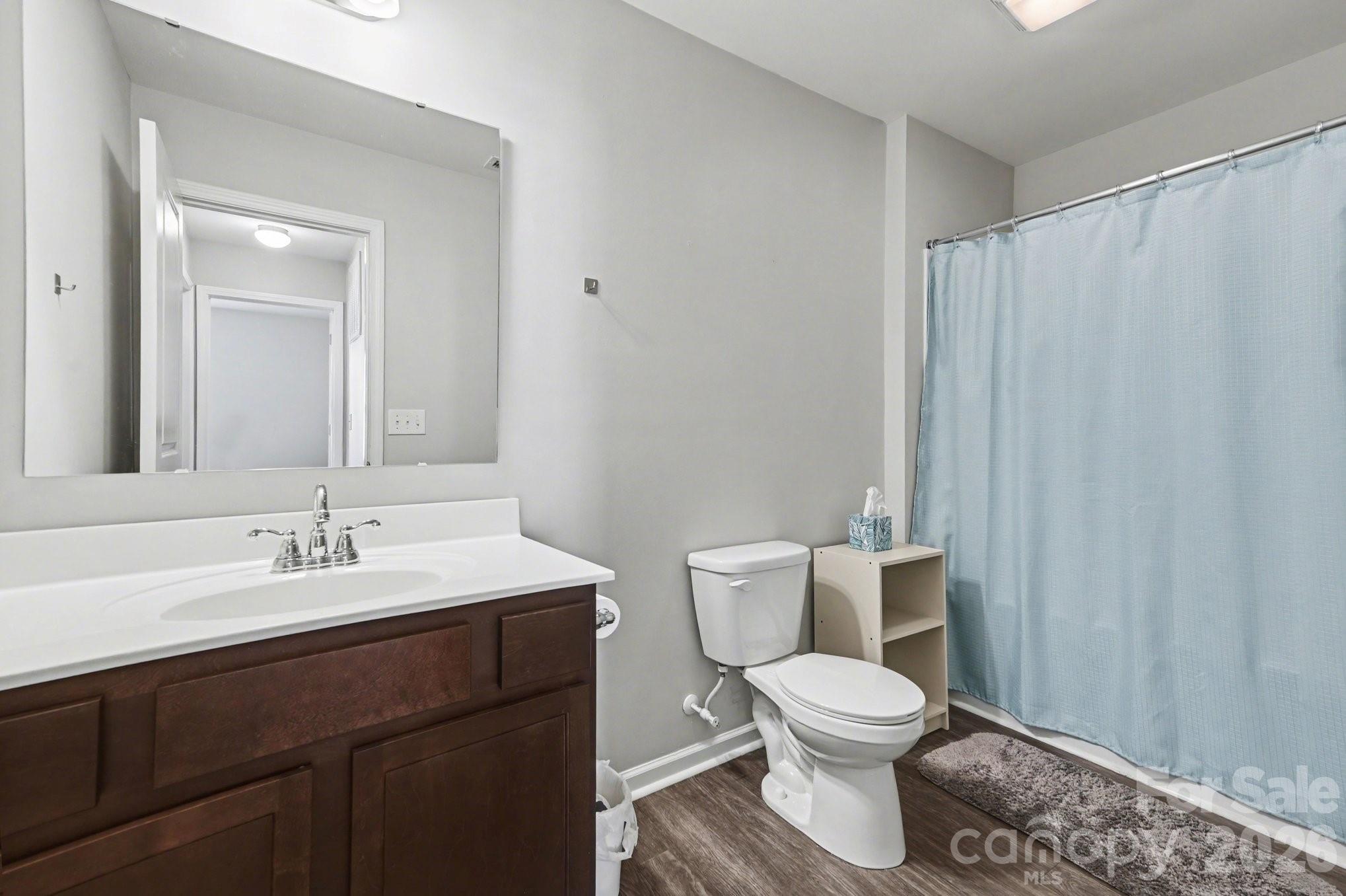 12527 Gotland Road Midland, NC 28107 - Photo 10 of 24 a bathroom with a toilet a sink and a mirror