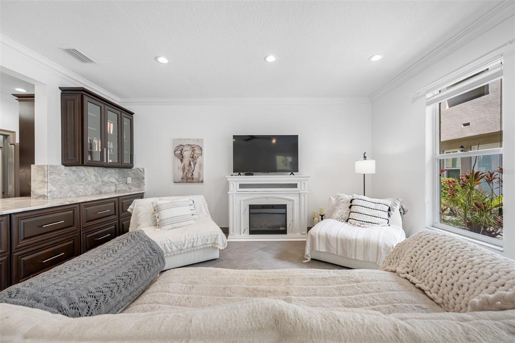 237 7th Avenue North, Unit 2 St. Petersburg, FL 33701 - Photo 13 of 60 a spacious bedroom with a large bed and a flat screen tv