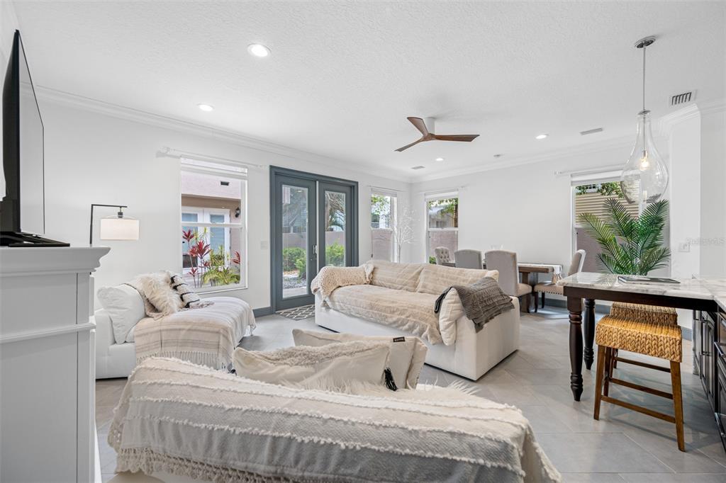 237 7th Avenue North, Unit 2 St. Petersburg, FL 33701 - Photo 17 of 60 a living room with furniture a window and a flat screen tv