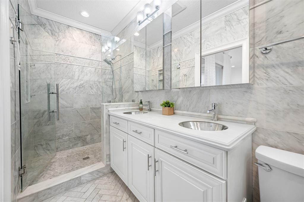 237 7th Avenue North, Unit 2 St. Petersburg, FL 33701 - Photo 38 of 60 a bathroom with a shower sink and mirror