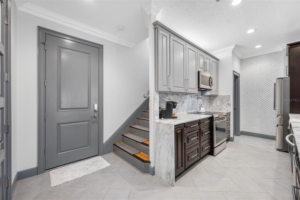 237 7th Avenue North, Unit 2 St. Petersburg, FL 33701 - Photo 4 of 60 a kitchen with stainless steel appliances a stove and a refrigerator