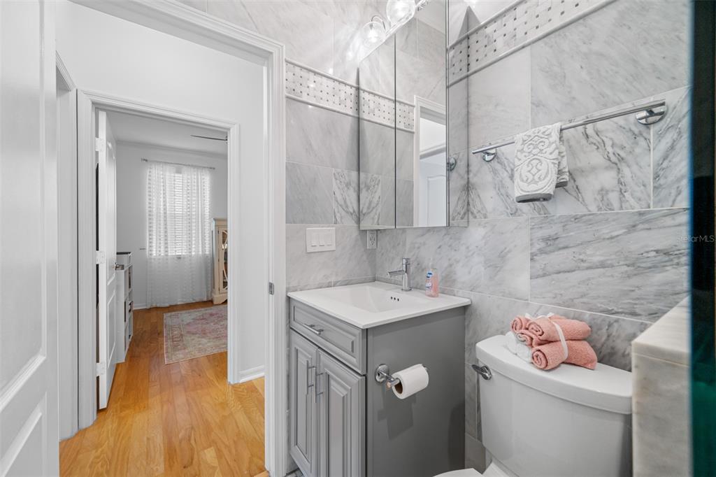 237 7th Avenue North, Unit 2 St. Petersburg, FL 33701 - Photo 45 of 60 a bathroom with a sink toilet vanity and shower