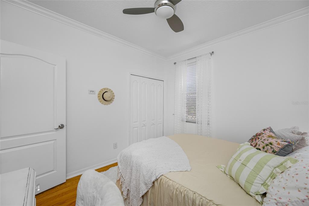 237 7th Avenue North, Unit 2 St. Petersburg, FL 33701 - Photo 47 of 60 a bedroom with a bed and a chandelier