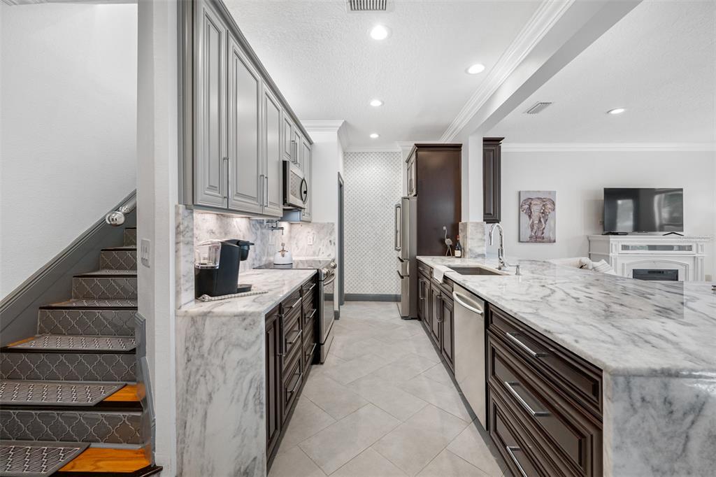 237 7th Avenue North, Unit 2 St. Petersburg, FL 33701 - Photo 5 of 60 a kitchen with stainless steel appliances granite countertop a sink and cabinets