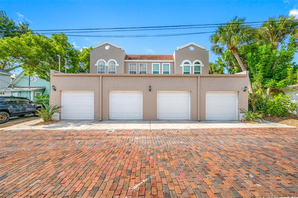 237 7th Avenue North, Unit 2 St. Petersburg, FL 33701 - Photo 51 of 60 a front view of a house with a yard and garage