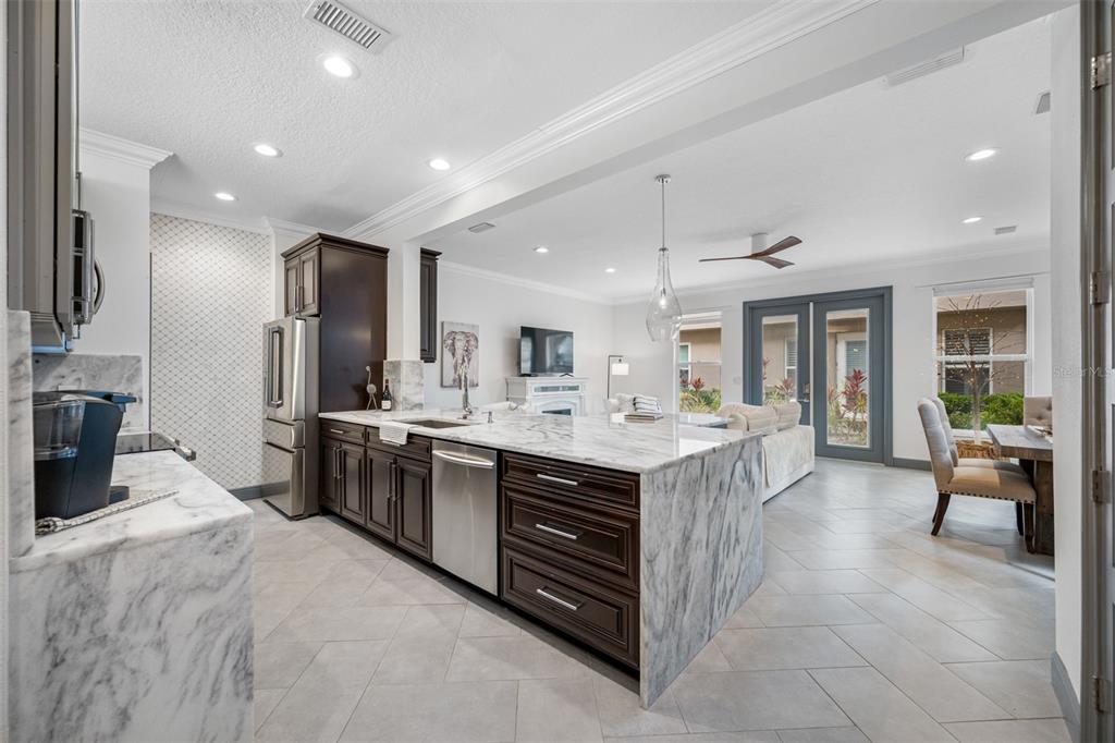 237 7th Avenue North, Unit 2 St. Petersburg, FL 33701 - Photo 6 of 60 a large kitchen with kitchen island a sink stainless steel appliances and cabinets