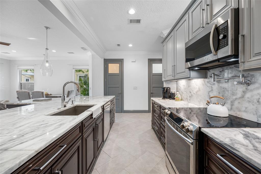 237 7th Avenue North, Unit 2 St. Petersburg, FL 33701 - Photo 7 of 60 a large kitchen with granite countertop a stove and a sink