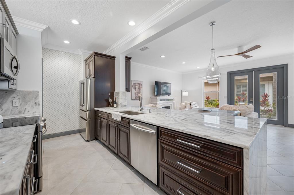 237 7th Avenue North, Unit 2 St. Petersburg, FL 33701 - Photo 8 of 60 a kitchen with stainless steel appliances granite countertop a sink and stove top oven