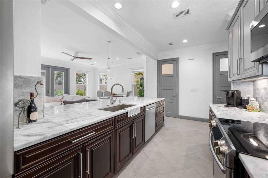 237 7th Avenue North, Unit 2 St. Petersburg, FL 33701 - Photo 9 of 60 a kitchen with sink stove and cabinets