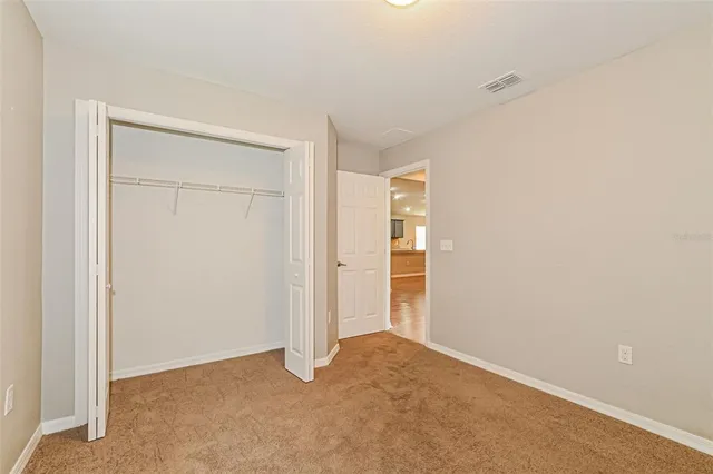 an empty room with closet area