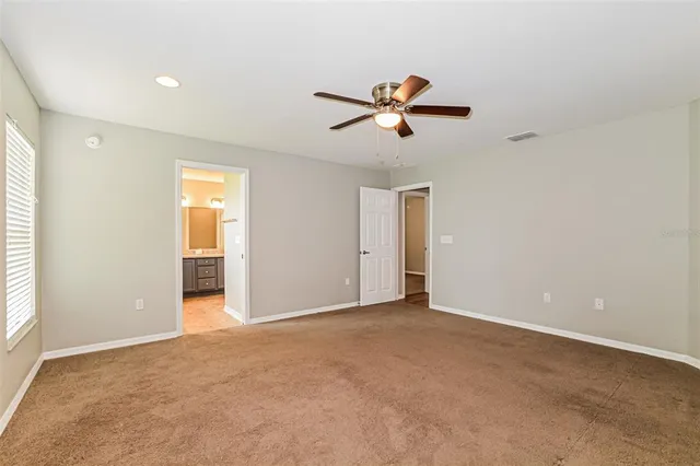 a view of room with a ceiling fan and window