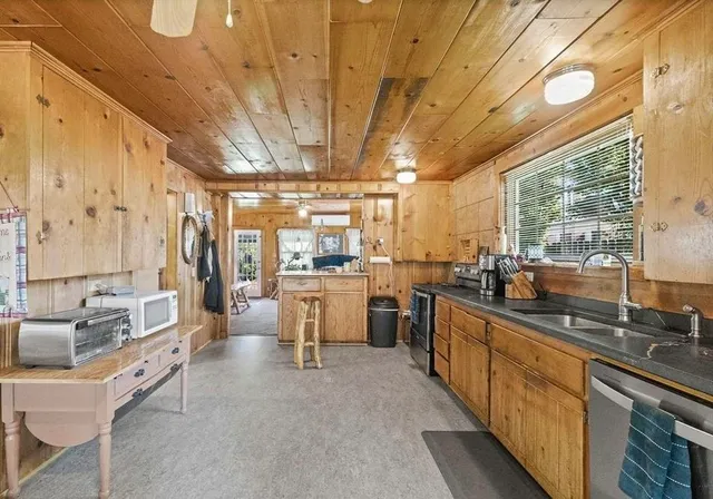a bathroom with a granite countertop shower mirror and a sink