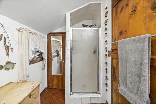 a view of a deck with two chairs and wooden fence