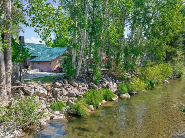 a view of a house with a yard and sitting area