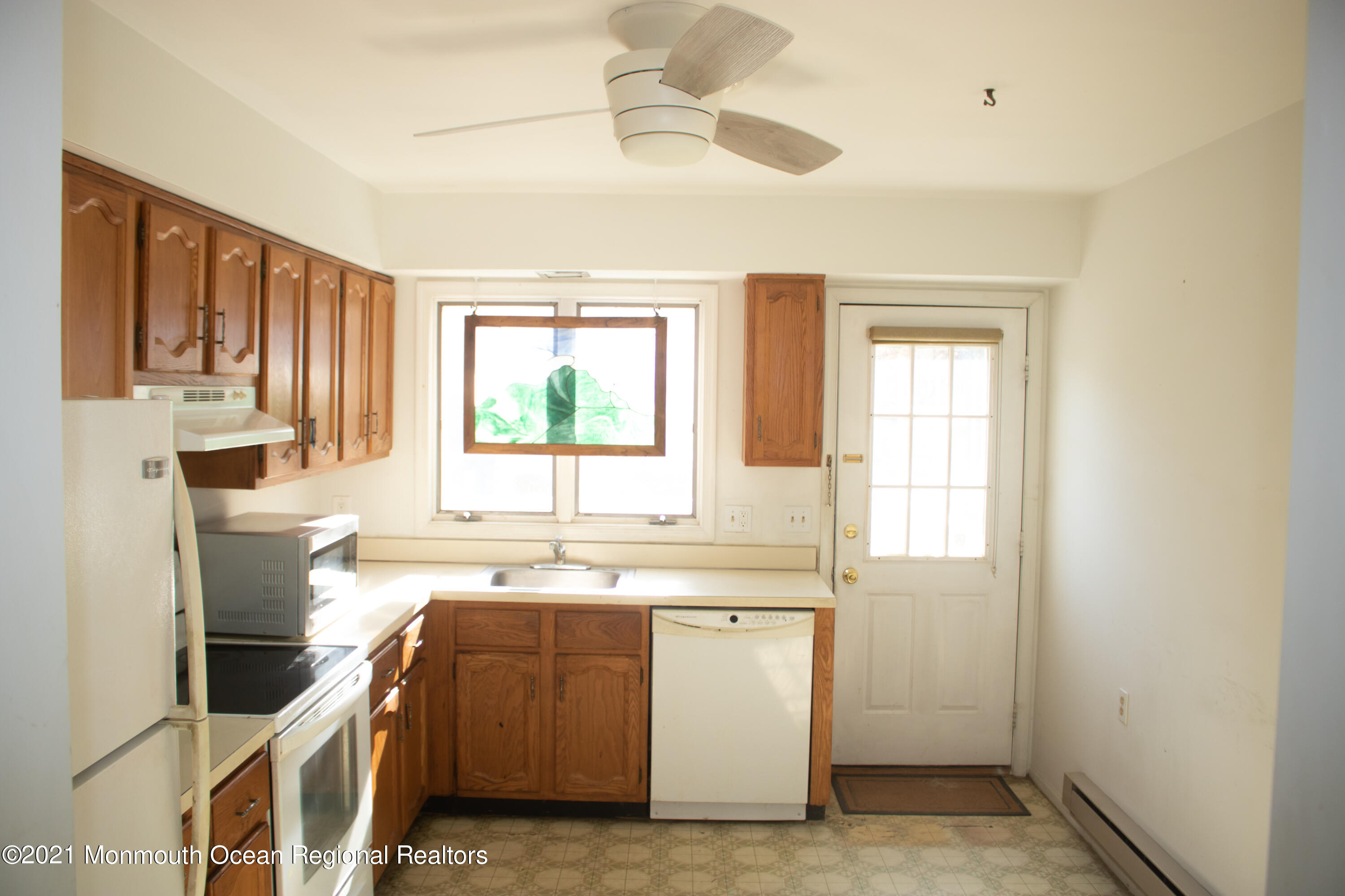 47 Sycamore Access Road Manahawkin, NJ 08050 - Photo 14 of 37 a kitchen with a sink stove and cabinets