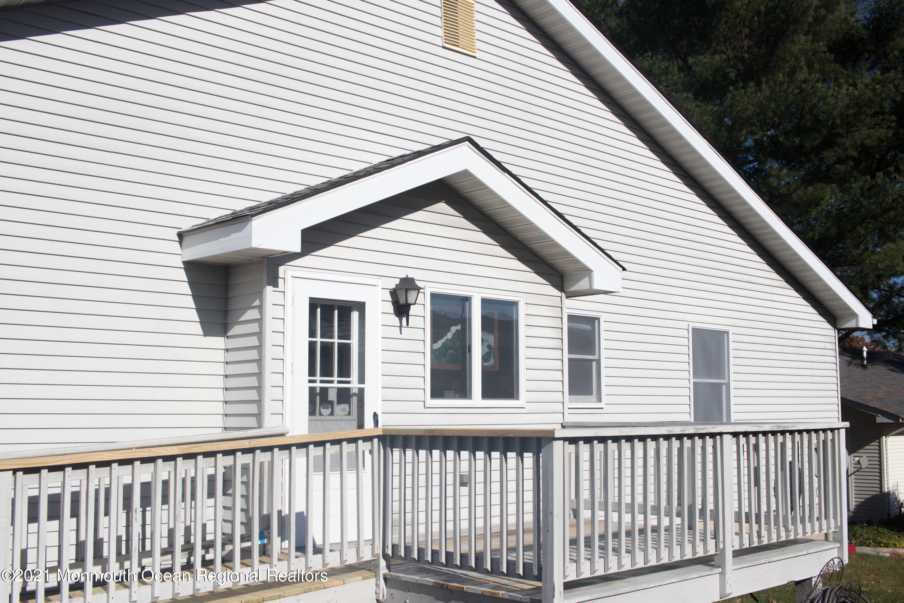 47 Sycamore Access Road Manahawkin, NJ 08050 - Photo 5 of 37 a view of a white house with wooden fence