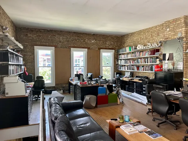a living room with furniture a rug and a bookshelf