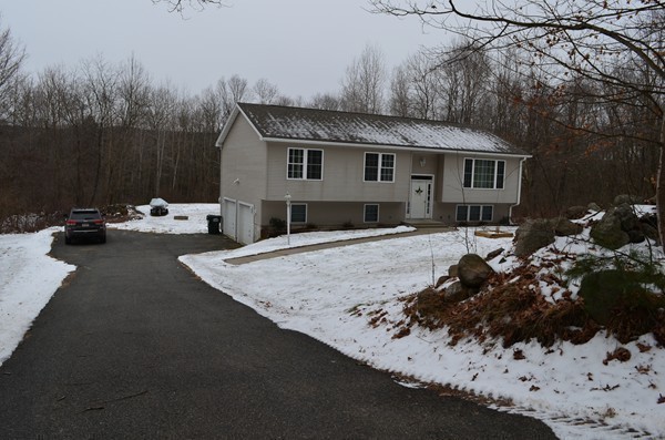 247 Collins Road Hardwick, MA 01082 - Photo 14 of 16 a view of a house with a yard covered in snow