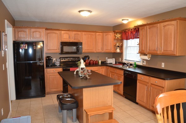 247 Collins Road Hardwick, MA 01082 - Photo 3 of 16 a kitchen with stainless steel appliances granite countertop a refrigerator and a stove top oven